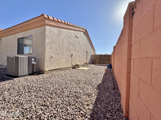 view of side of home featuring central AC