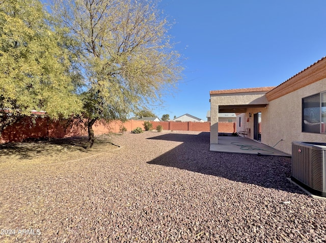 view of yard featuring a patio area and central air condition unit