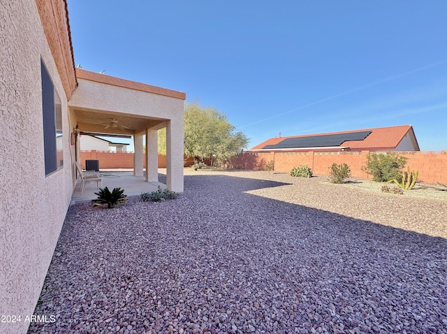 view of yard with a patio area and ceiling fan