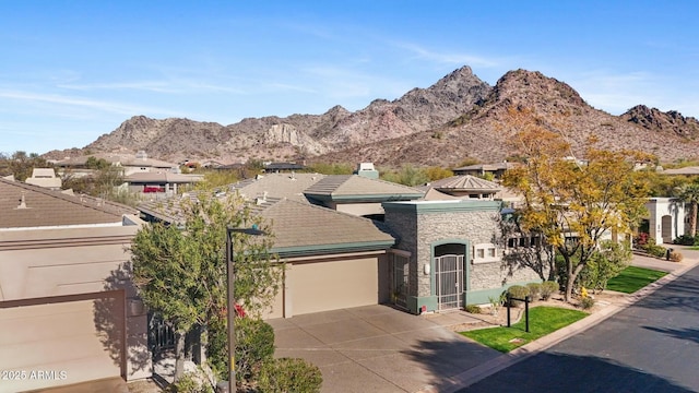 view of front of property featuring a mountain view and a garage