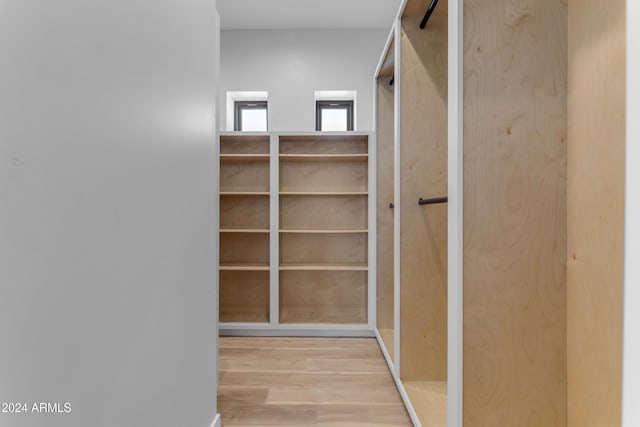 spacious closet featuring light hardwood / wood-style flooring