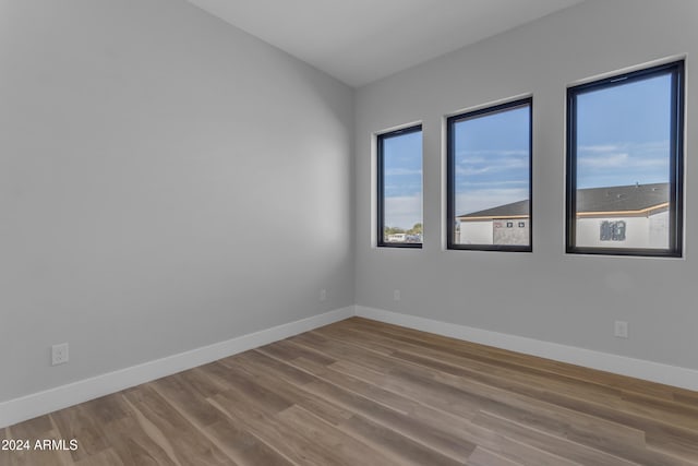 unfurnished room featuring hardwood / wood-style flooring