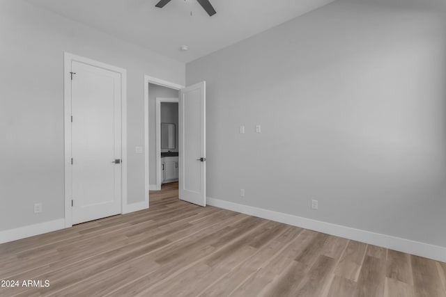 unfurnished bedroom with ceiling fan and light hardwood / wood-style flooring