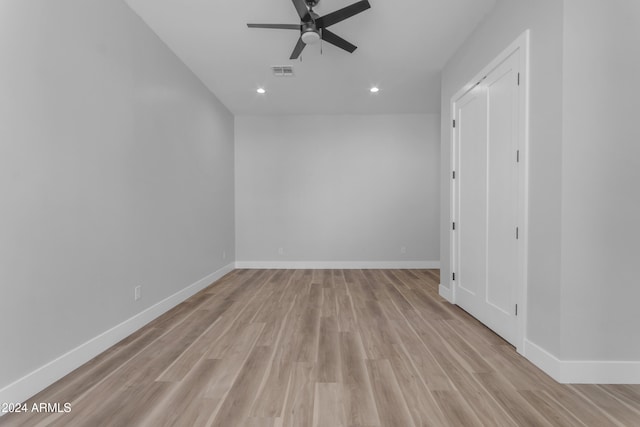 spare room with light wood-type flooring and ceiling fan