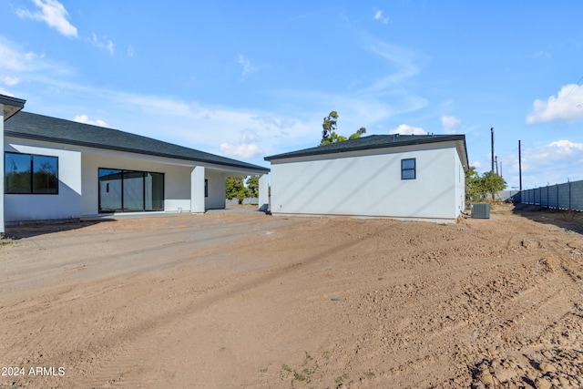 rear view of house with central air condition unit