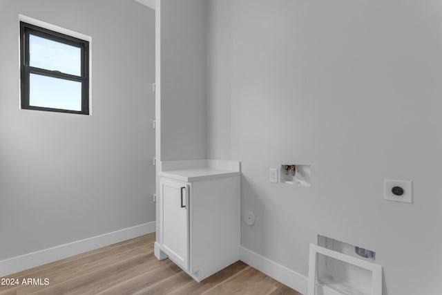 laundry area featuring gas dryer hookup, washer hookup, hookup for an electric dryer, and light hardwood / wood-style flooring