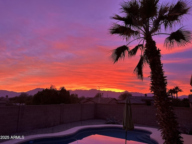 pool at dusk with a mountain view