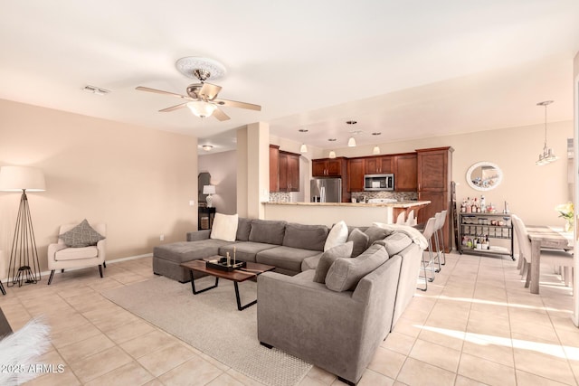 tiled living room with ceiling fan