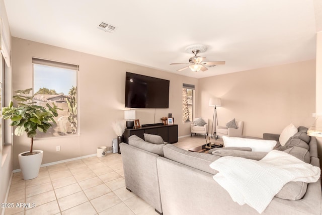 tiled living room with ceiling fan