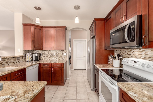 kitchen featuring light stone countertops, appliances with stainless steel finishes, and decorative light fixtures