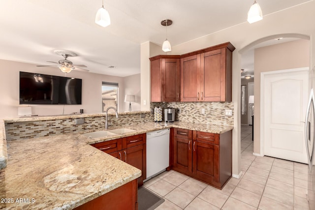 kitchen featuring pendant lighting, dishwasher, light stone countertops, and sink