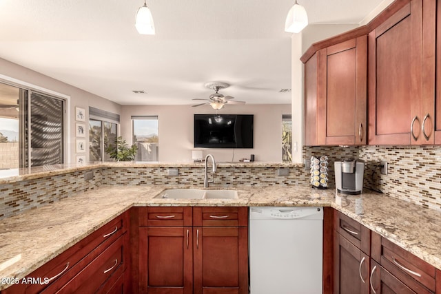 kitchen featuring dishwasher, backsplash, sink, ceiling fan, and light stone countertops