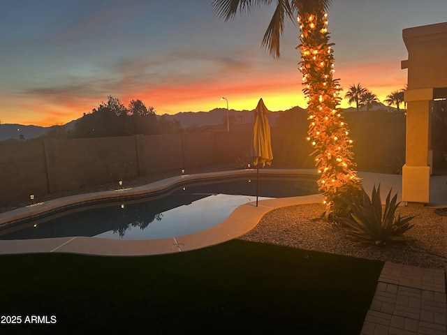 pool at dusk with a mountain view