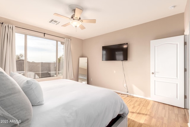 bedroom with light hardwood / wood-style floors and ceiling fan