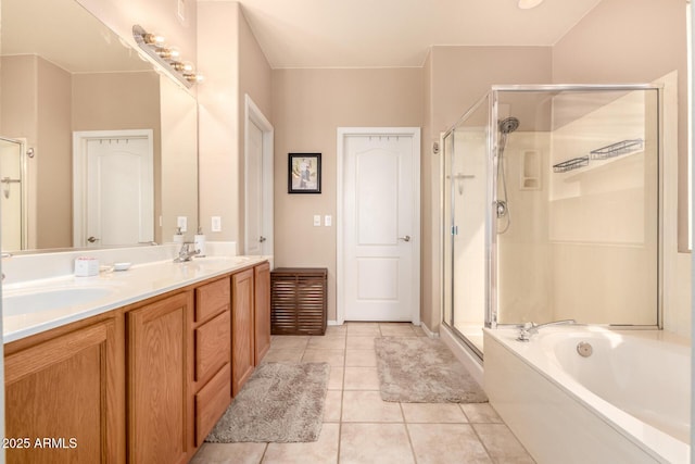 bathroom with tile patterned floors, vanity, and separate shower and tub