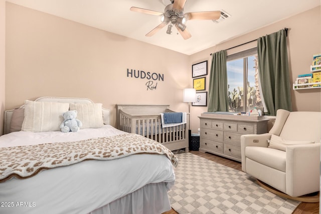 bedroom featuring ceiling fan and light hardwood / wood-style flooring