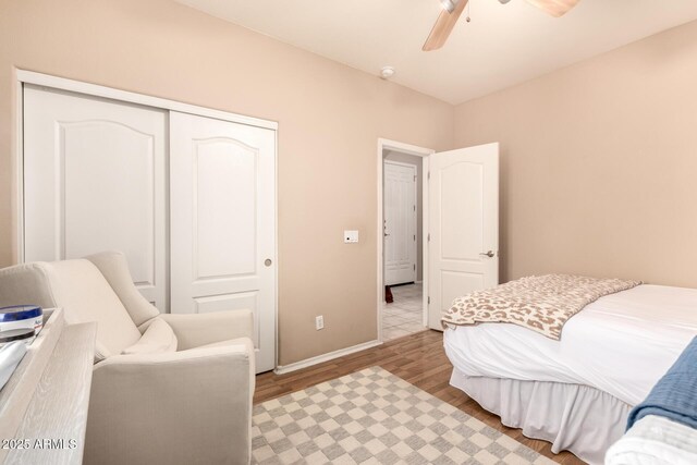 bedroom with ceiling fan, a closet, and light wood-type flooring