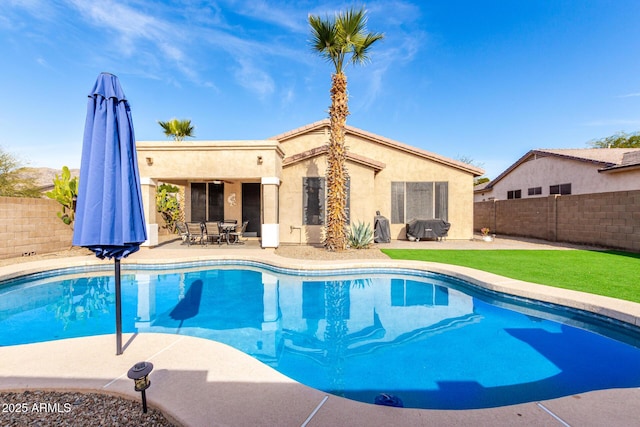 view of pool with a grill and a patio area