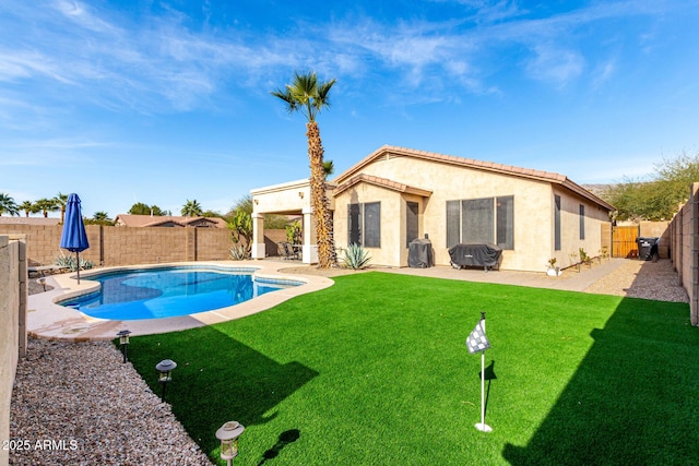 view of swimming pool featuring a yard and a patio