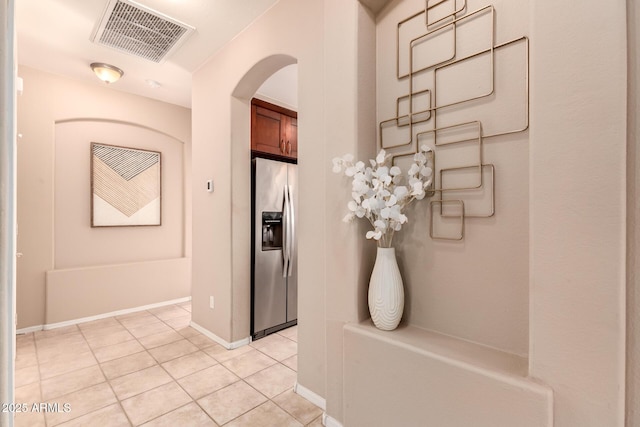 hall with light tile patterned floors