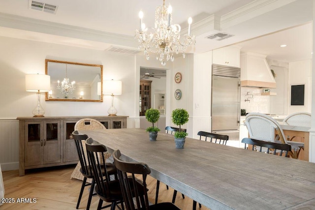 dining space with ceiling fan, light parquet floors, and ornamental molding