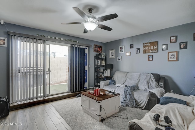 living room featuring light hardwood / wood-style flooring and ceiling fan