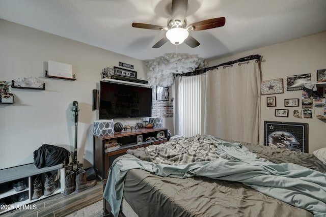 bedroom with ceiling fan and hardwood / wood-style floors