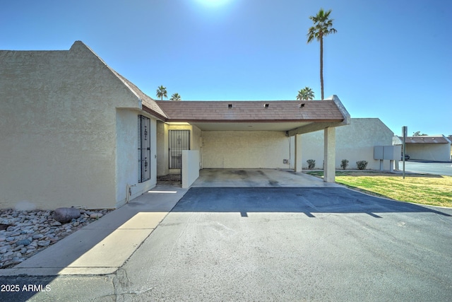 rear view of property with a carport