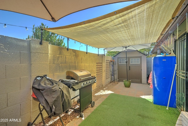 view of patio featuring area for grilling and a shed