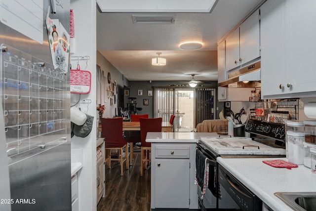 kitchen featuring black appliances, white cabinetry, dark hardwood / wood-style flooring, ceiling fan, and kitchen peninsula