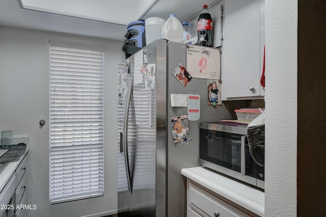 kitchen with stainless steel appliances and white cabinets