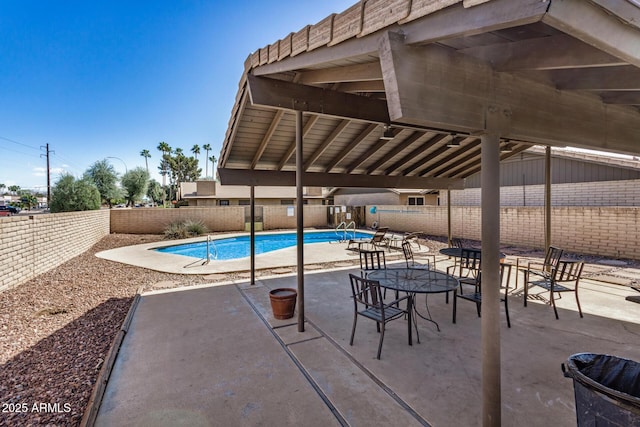 view of swimming pool featuring a patio, a fenced backyard, and a fenced in pool