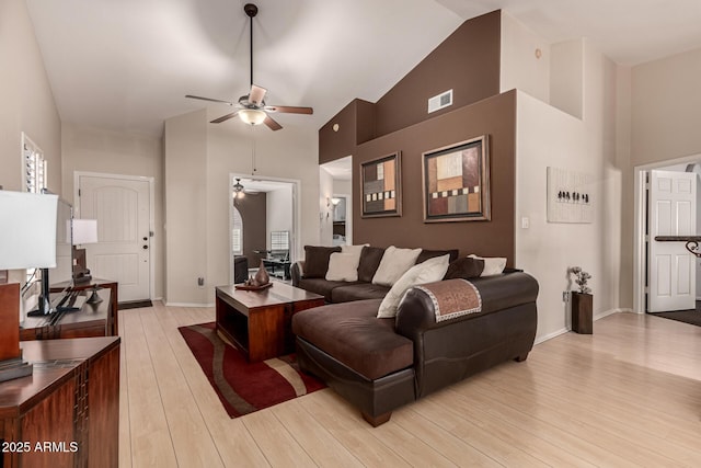 living room with high vaulted ceiling, light wood-type flooring, and ceiling fan