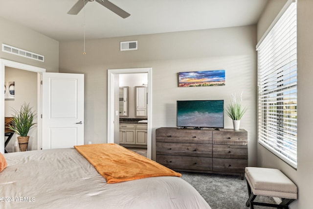 carpeted bedroom featuring connected bathroom, multiple windows, and visible vents