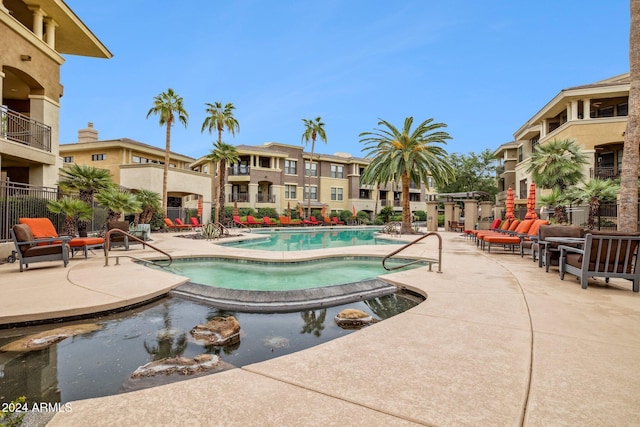 pool with fence and a patio area