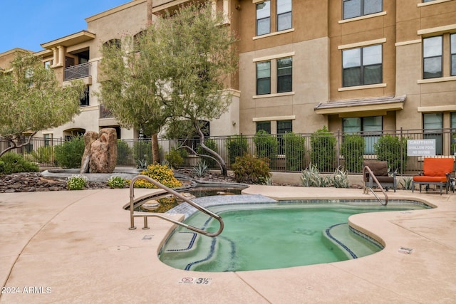 view of swimming pool with a swimming pool, a patio area, and fence
