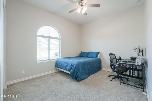 bedroom with ceiling fan and light carpet