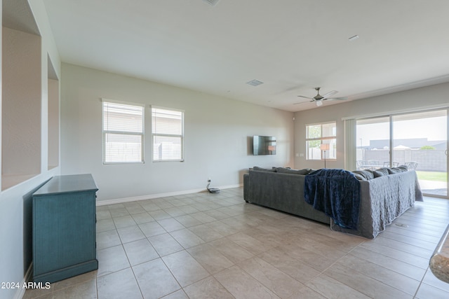 tiled living room with ceiling fan