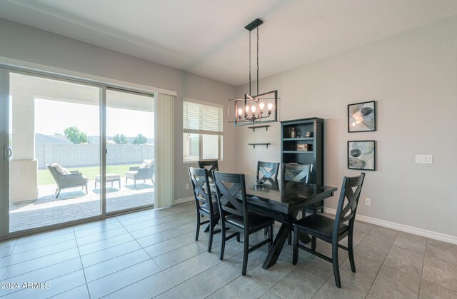 dining room with tile patterned floors and a chandelier