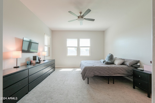 bedroom featuring ceiling fan and light carpet