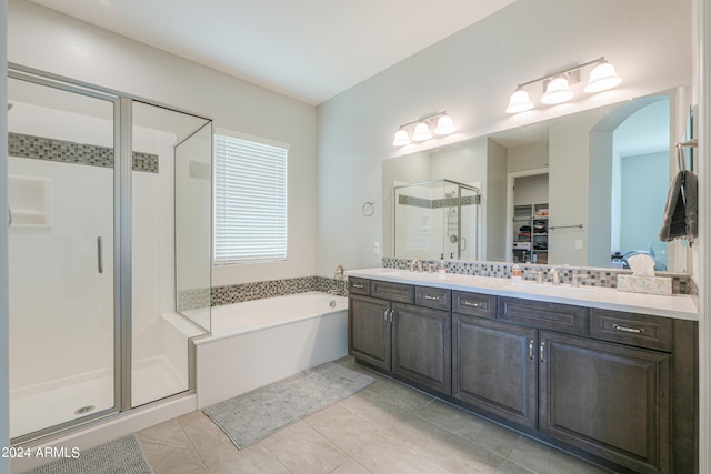 bathroom featuring tile patterned floors, shower with separate bathtub, and double vanity