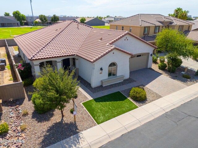 mediterranean / spanish home with a garage, central air condition unit, and a front yard