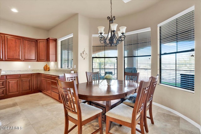 dining area with a notable chandelier and light tile floors