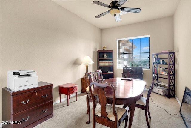 carpeted dining room with ceiling fan