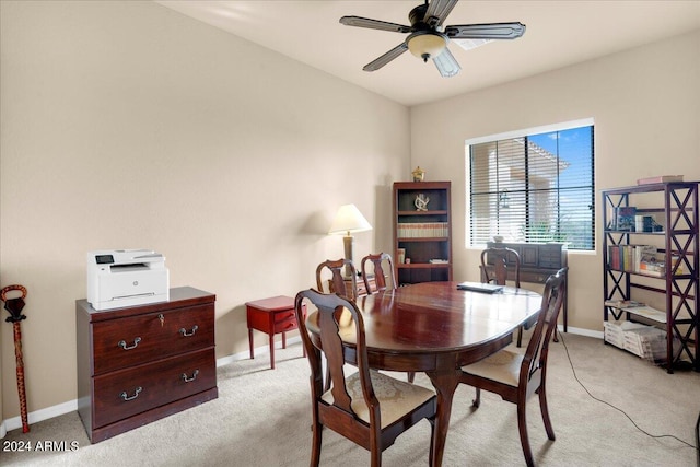 dining room with light carpet and ceiling fan