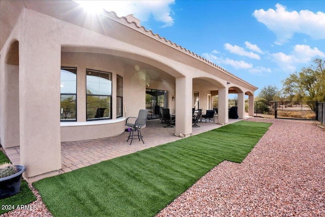 rear view of house with a patio area and a yard