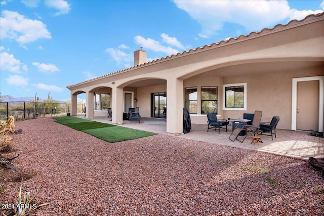 rear view of house with a patio area