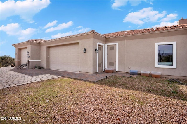 mediterranean / spanish-style home with a garage