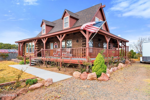 log cabin with covered porch