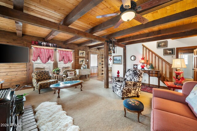 living room with beam ceiling, a wealth of natural light, wood ceiling, and wood walls